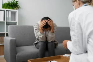 A woman sitting on a couch with a doctor discussing Depression mental health Billing Process.